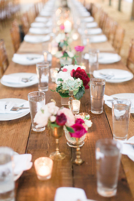 Long rustic wedding table with flower centerpieces