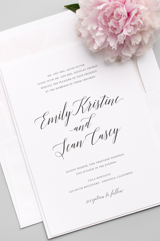 Elegant wedding invitation with calligraphy and a pink flower