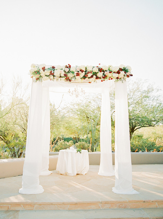 Wedding chuppah canopy with red and white flowers