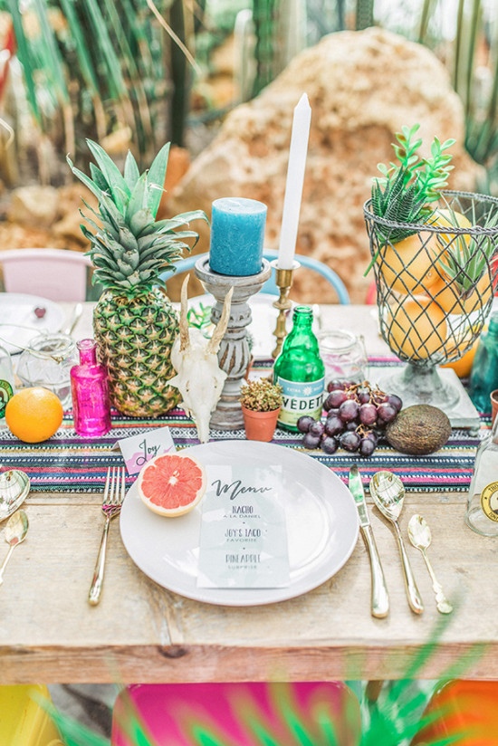 Festive table setting with pineapple, fruits and menu decoration