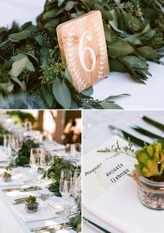 Wedding table decor with greenery and wooden table number six