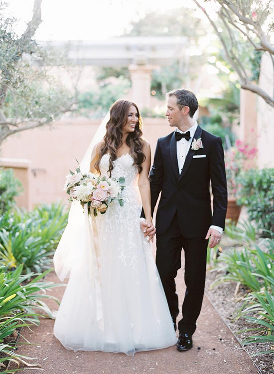 Happy bride and groom walking down aisle