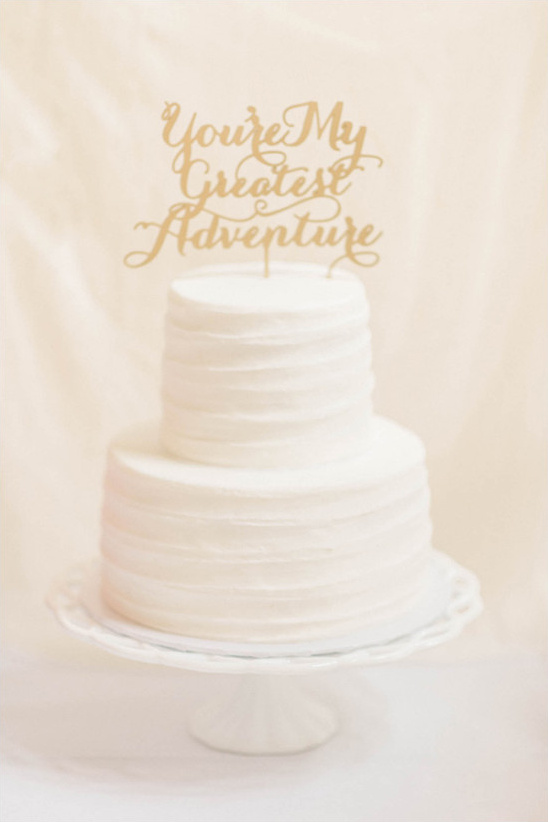 Two-tier wedding cake with topper You're My Greatest Adventure