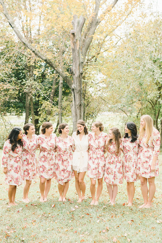 Bridesmaids and bride wearing floral robes at outdoor wedding ceremony