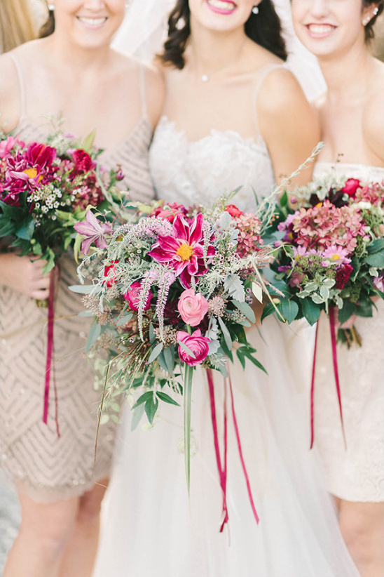 Bridesmaids with vibrant bouquets and smiles on a wedding day