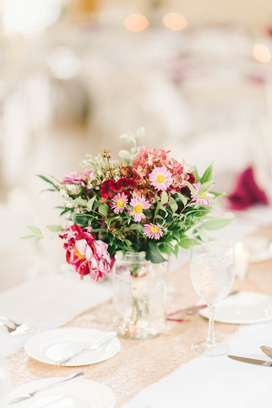 Elegant floral centerpiece on a wedding reception table setting