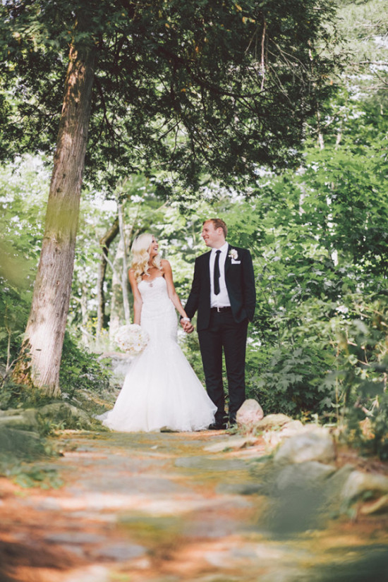 Romantic wedding couple holding hands in a forest setting