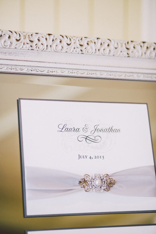 Elegant wedding invitation with vintage brooch and ribbon