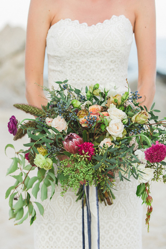Bride holding vibrant wedding bouquet, close-up photo