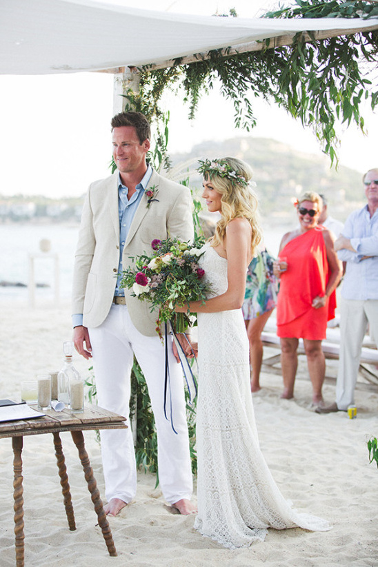 Beach wedding couple exchanging vows in a ceremony