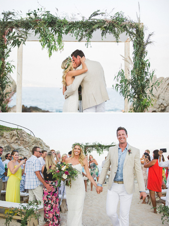 Bride and groom kissing at a beautiful beach wedding ceremony