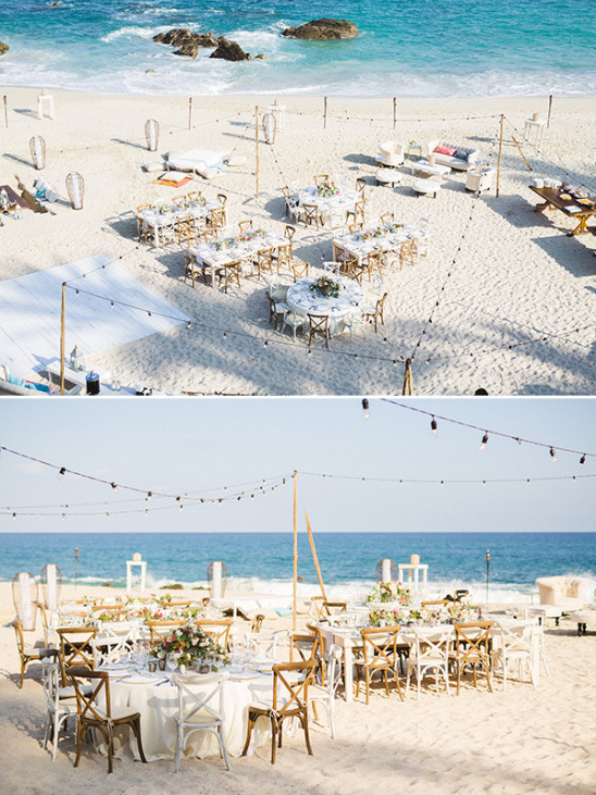 Beach wedding reception setup with tables and ocean views
