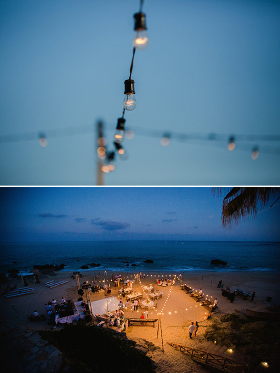 Beach wedding reception with string lights at night
