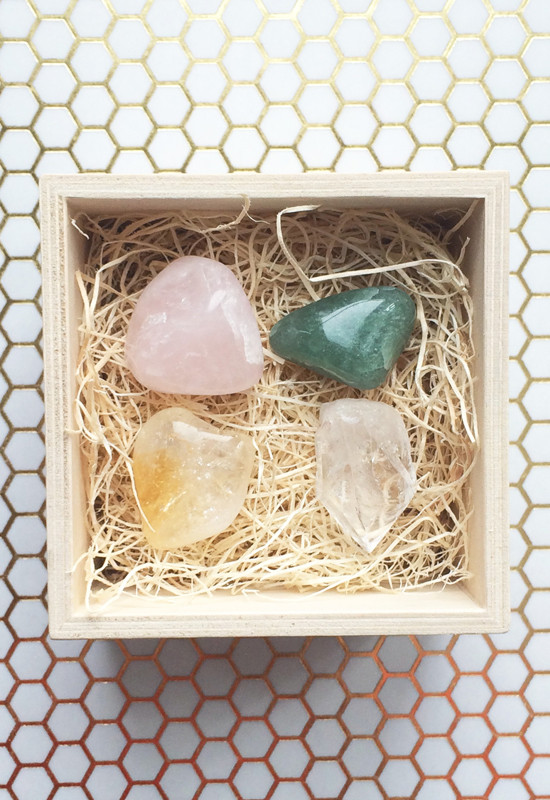 Set of crystals in a wooden box on a decorative background