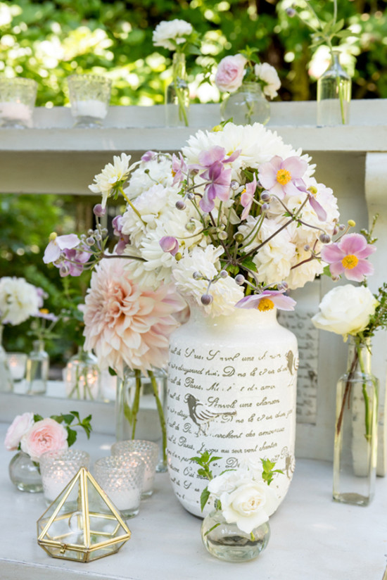 Elegant floral arrangement in a vase, with candles and decor