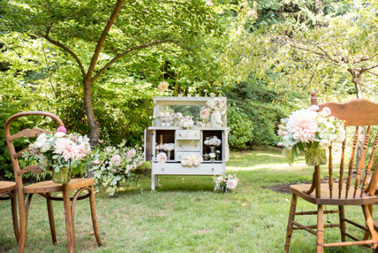 Outdoor garden wedding setup with chairs and floral decorations