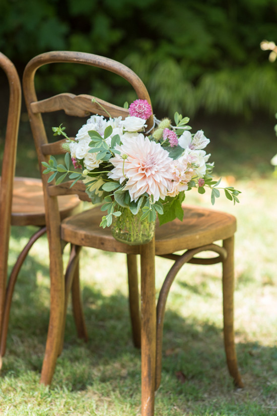 Wooden chair with floral bouquet, perfect for a garden party