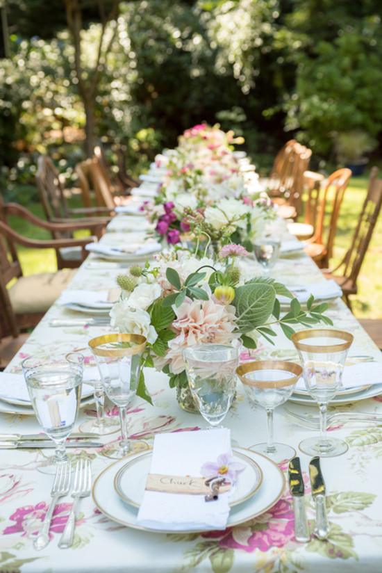 Elegant outdoor dining table set for a garden party with flowers