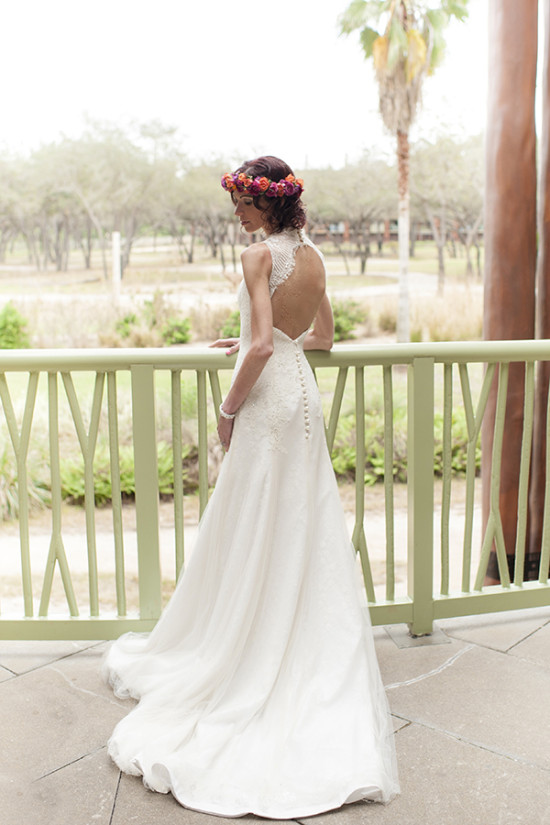 Bride wearing a floral crown and elegant wedding dress, outdoors