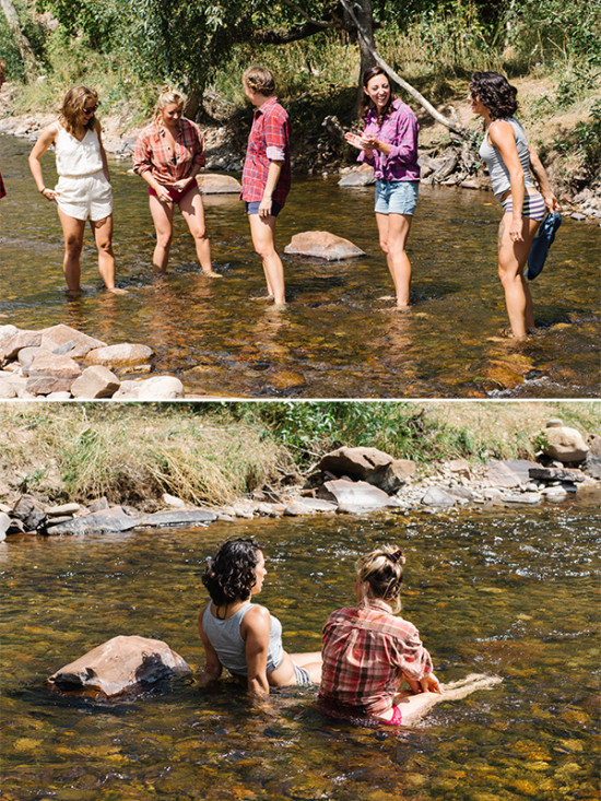 Friends enjoying a sunny day wading and relaxing in a clear river