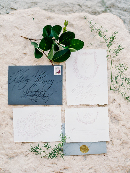 Elegant wedding invitations with calligraphy and botanical accents