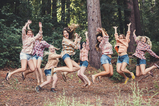 Happy friends jumping in the air, outdoor adventure, smiles, and fun!
