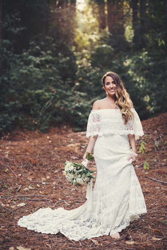 Beautiful bride in a lace wedding dress in a forest setting