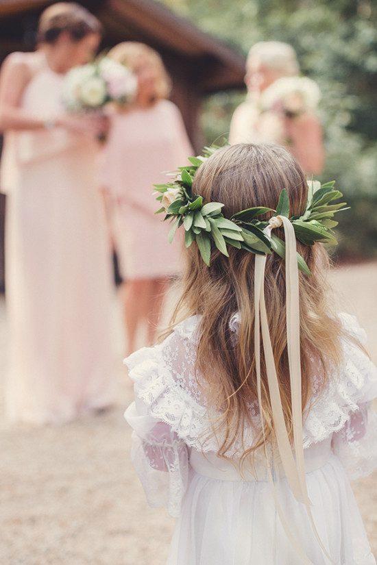 Flower girl at wedding with a green flower crown and ribbons