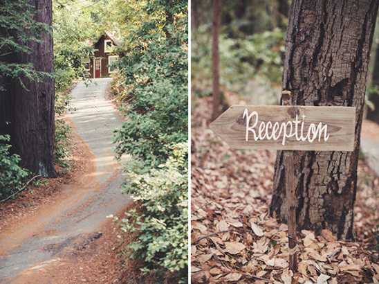 Wedding reception sign in the woods with the road to the party
