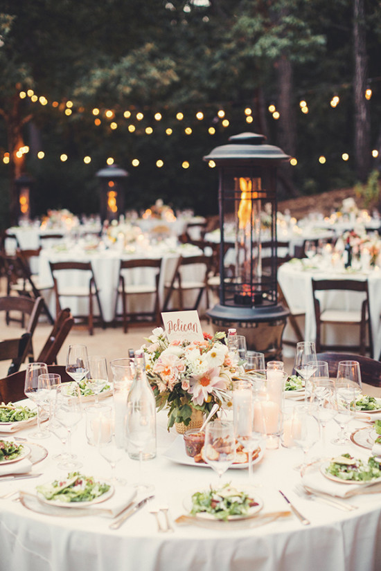 Elegant outdoor wedding reception table setting with lights
