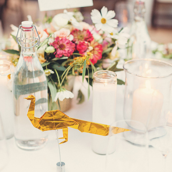 Elegant table setting with origami peacock centerpiece and flowers