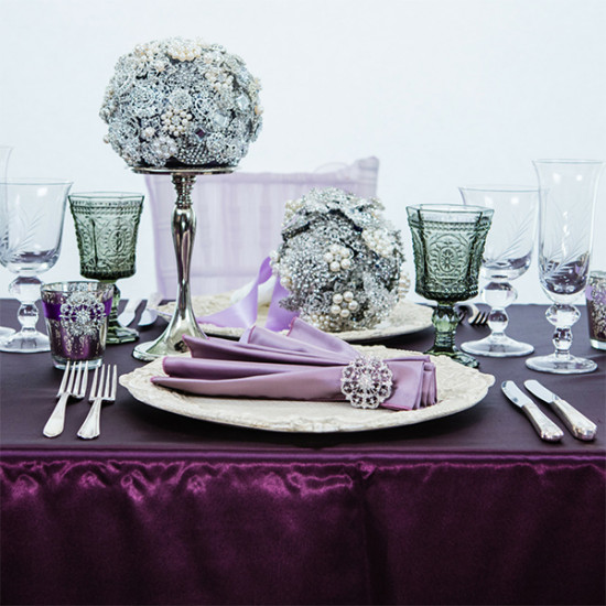 Elegant table setting with purple accents and ornate silverware