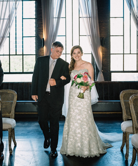 Bride walks down the aisle with her father at a wedding