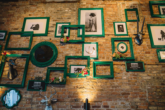 Gallery wall with framed art and decor on a brick wall