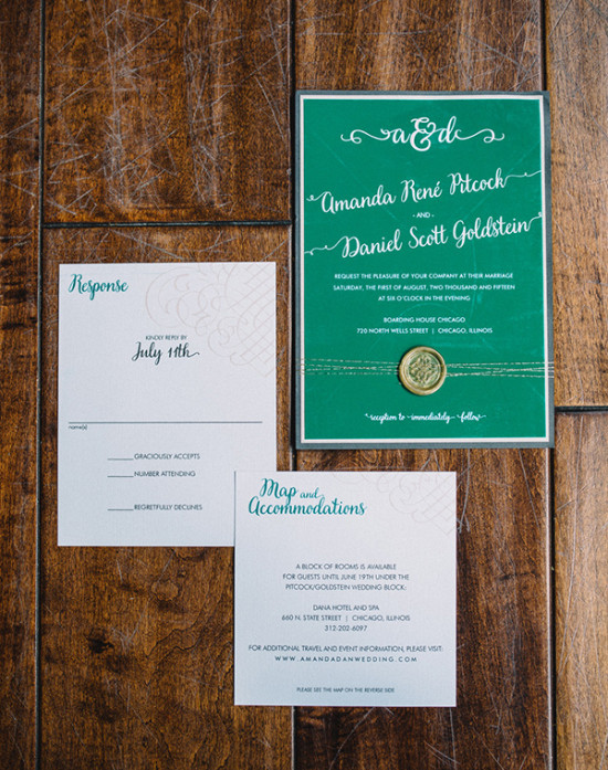 Wedding invitation suite with green and white details on wood