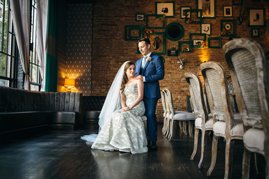 Bride and groom posing at wedding reception, vintage decor