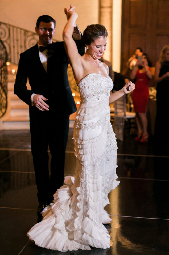 Bride and groom sharing a joyous first dance at their wedding reception