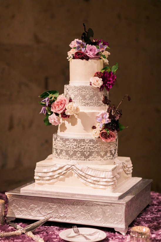 Elegant four-tier wedding cake with floral decorations