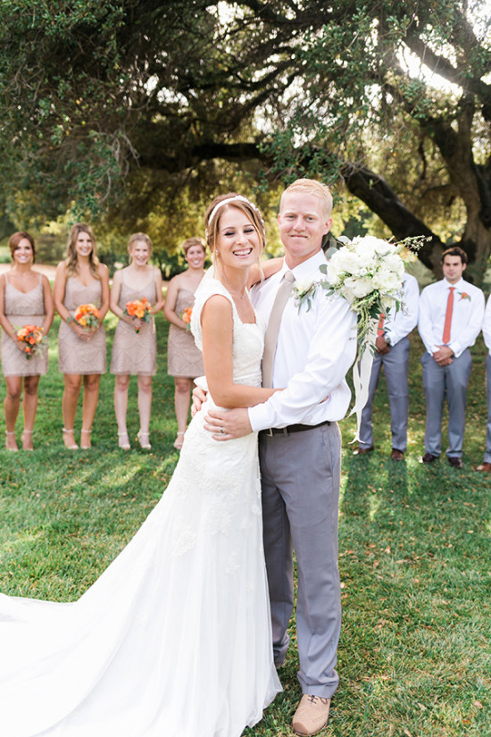Happy bride and groom smile during a beautiful outdoor wedding