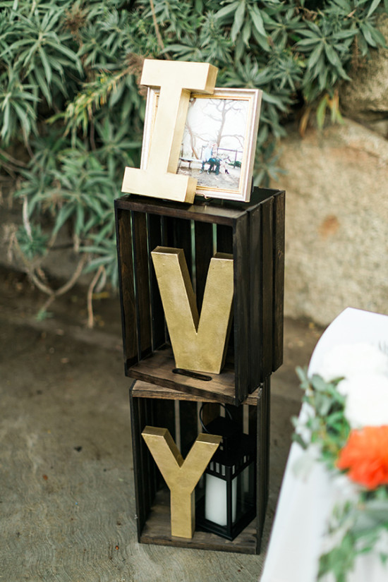 Gold letters IVY decor on wooden crates with a picture frame