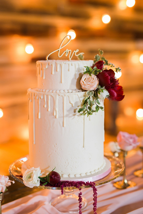 White drip wedding cake with love topper