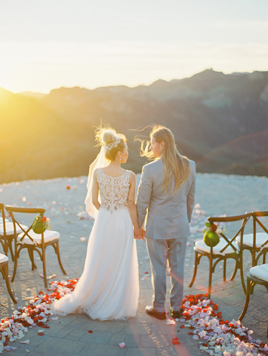 Couple holding hands at a wedding ceremony in the mountains