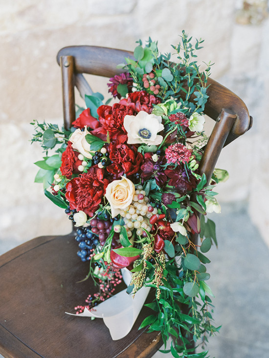 Elegant red and white wedding bouquet on a vintage wooden chair
