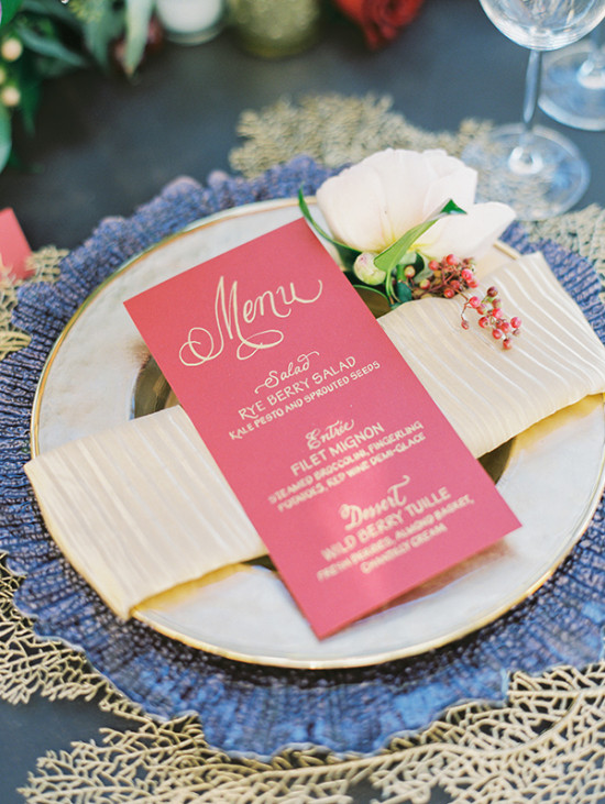 Elegant table setting with menu and flower on a silver plate