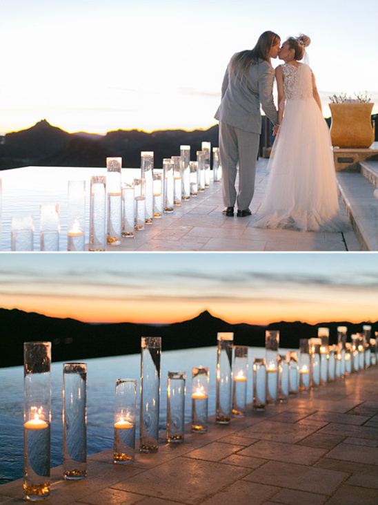 Couple kissing at sunset wedding ceremony with candles