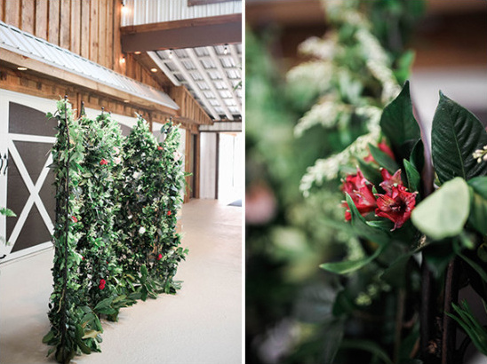 Decorative green plant wall with red flowers in barn