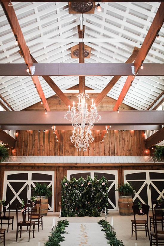 Barn wedding venue with chandelier and wooden accents