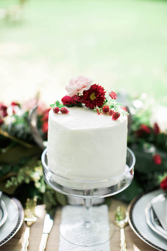 Elegant white cake with pink red flower decorations