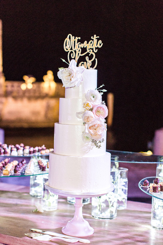 White wedding cake with gold topper
