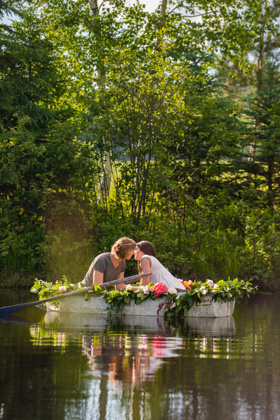 Couple kissing in flower decked boat on a peaceful lake